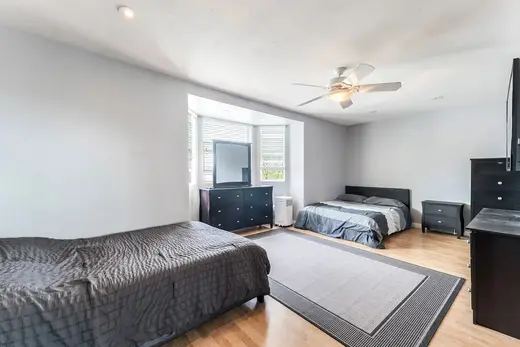 Cozy bedroom with two beds at The Park House Sober Living, a sober living home in Los Angeles.